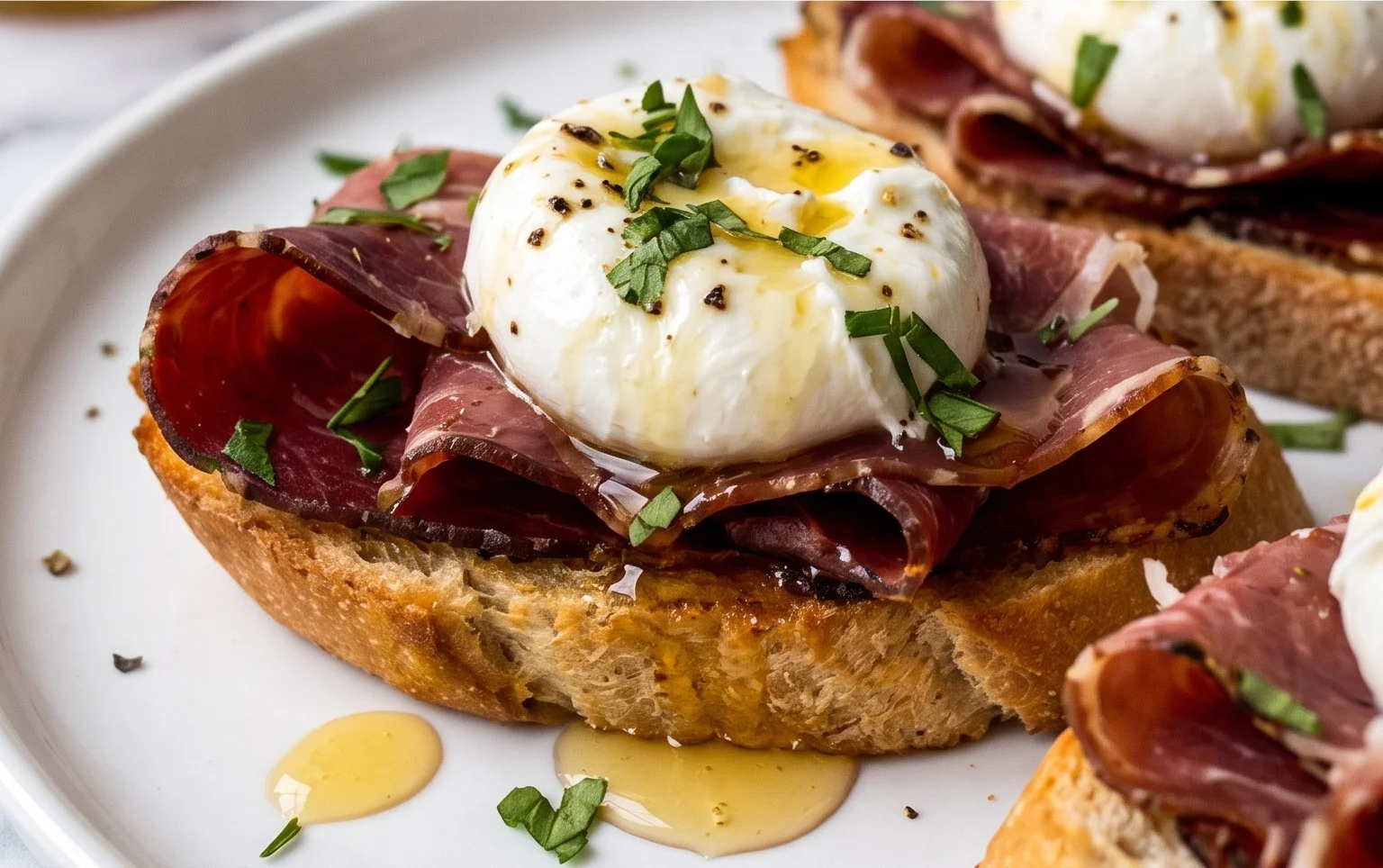 Beef Prosciutto Crostini with Burrata and Lemon Honey Drizzle