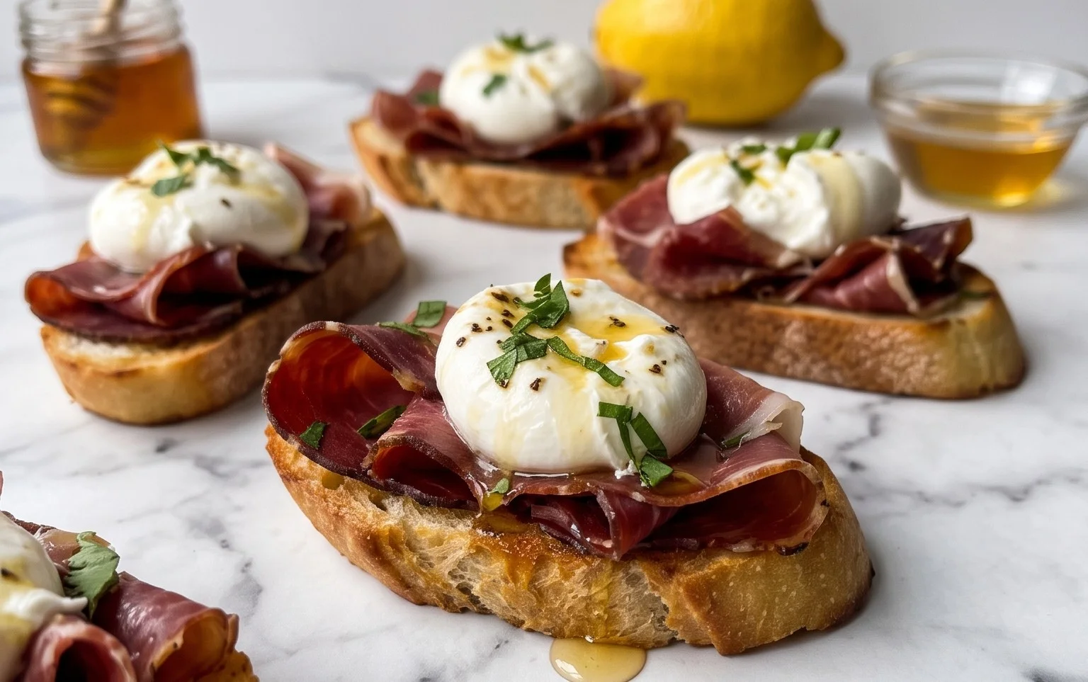 Beef Prosciutto Crostini with Burrata and Lemon Honey Drizzle